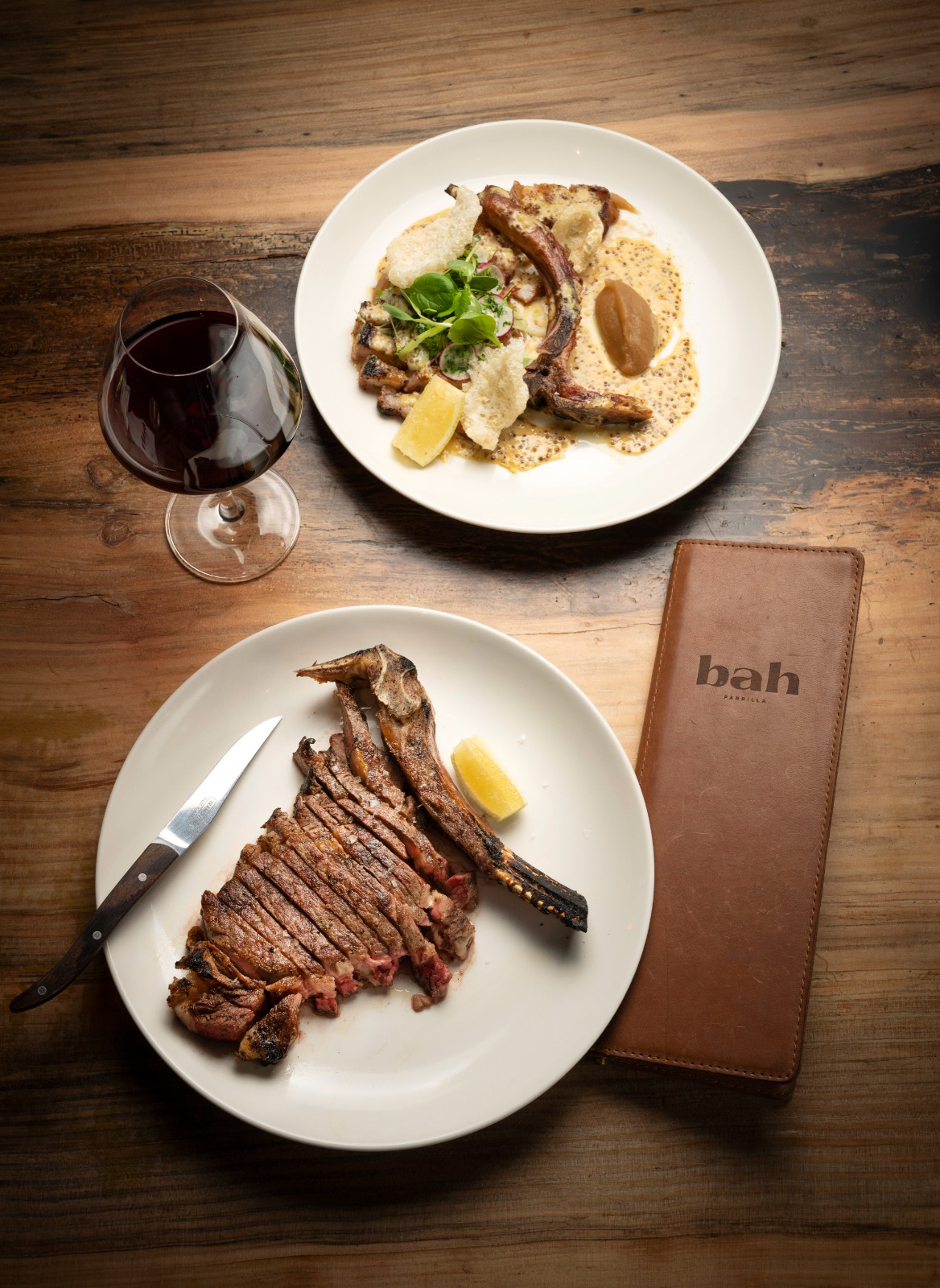 A steak searing on the wood-fired parrilla